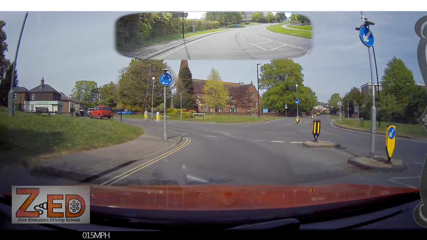 360-degree view from a vehicle's dashboard camera showing a road intersection with traffic signs and a church.