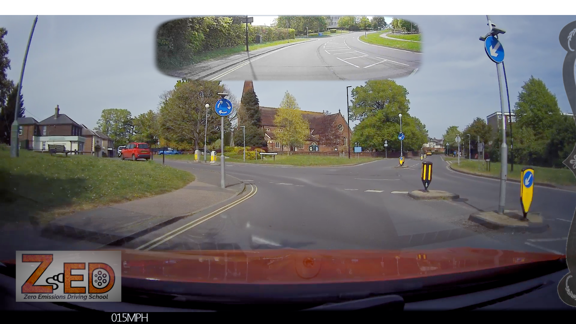 360-degree view from a vehicle's dashboard camera showing a road intersection with traffic signs and a church.