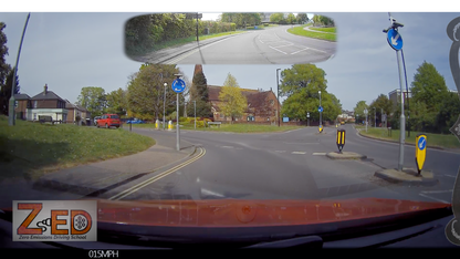 360-degree view from a vehicle's dashboard camera showing a road intersection with traffic signs and a church.