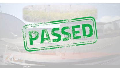 A green distressed rubber stamp graphic with the word 'PASSED' in bold uppercase letters, overlaid on a faded background of a car and outdoor scenery.